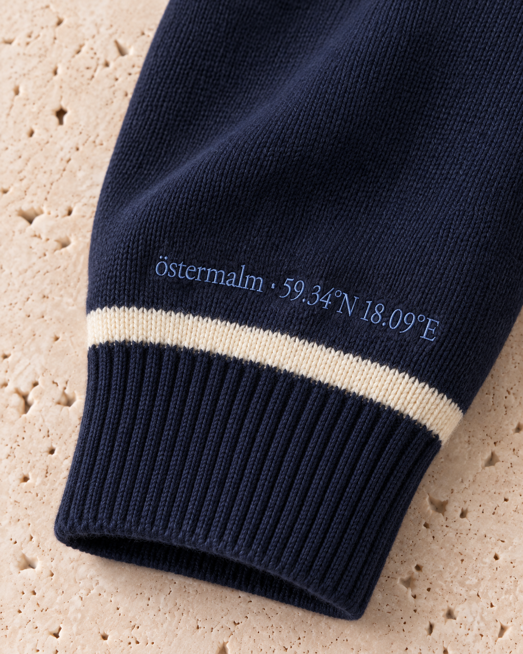 the merino crewneck in navy · östermalm — cuff embroidery detail