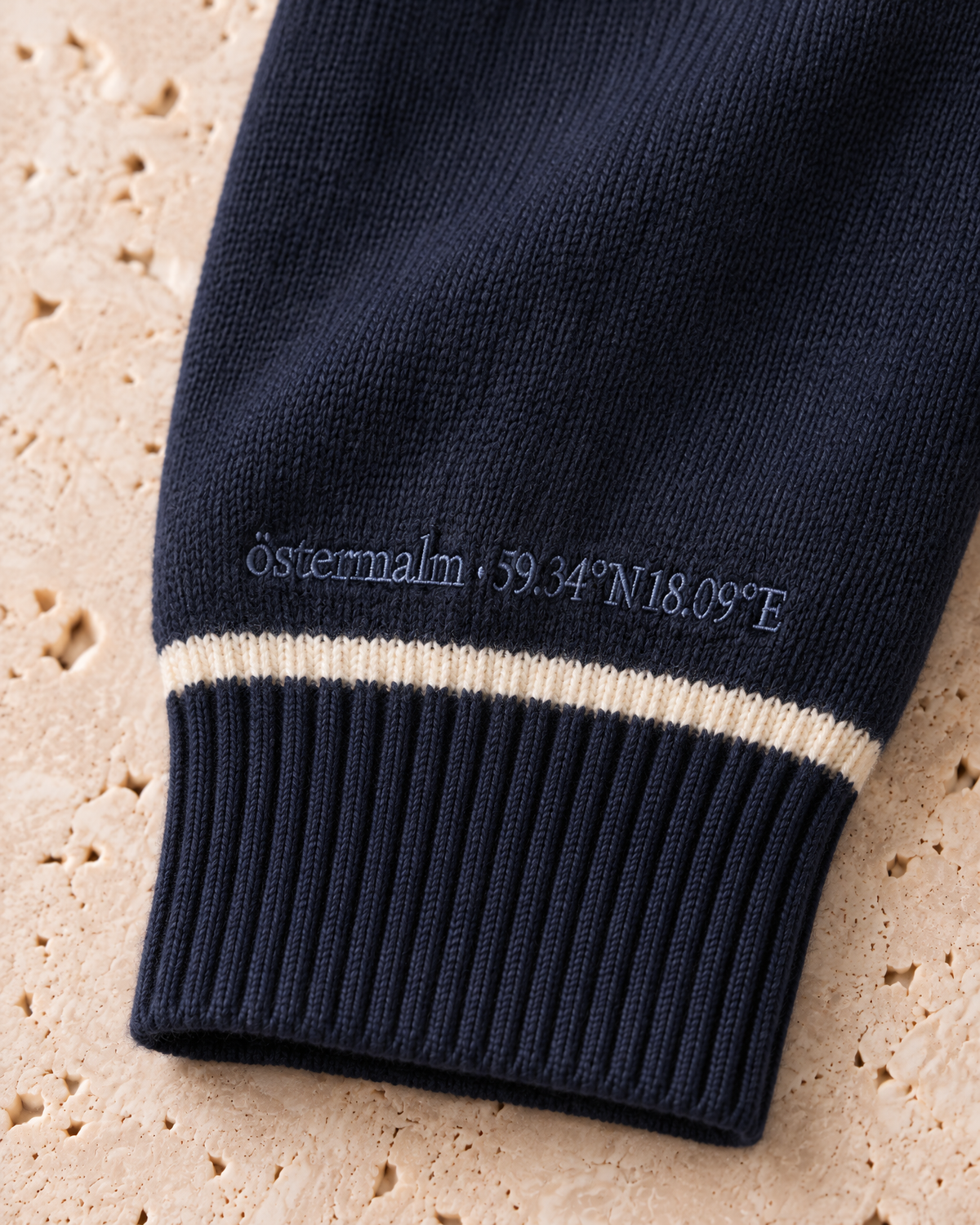 the knitted polo in navy · östermalm — cuff embroidery detail