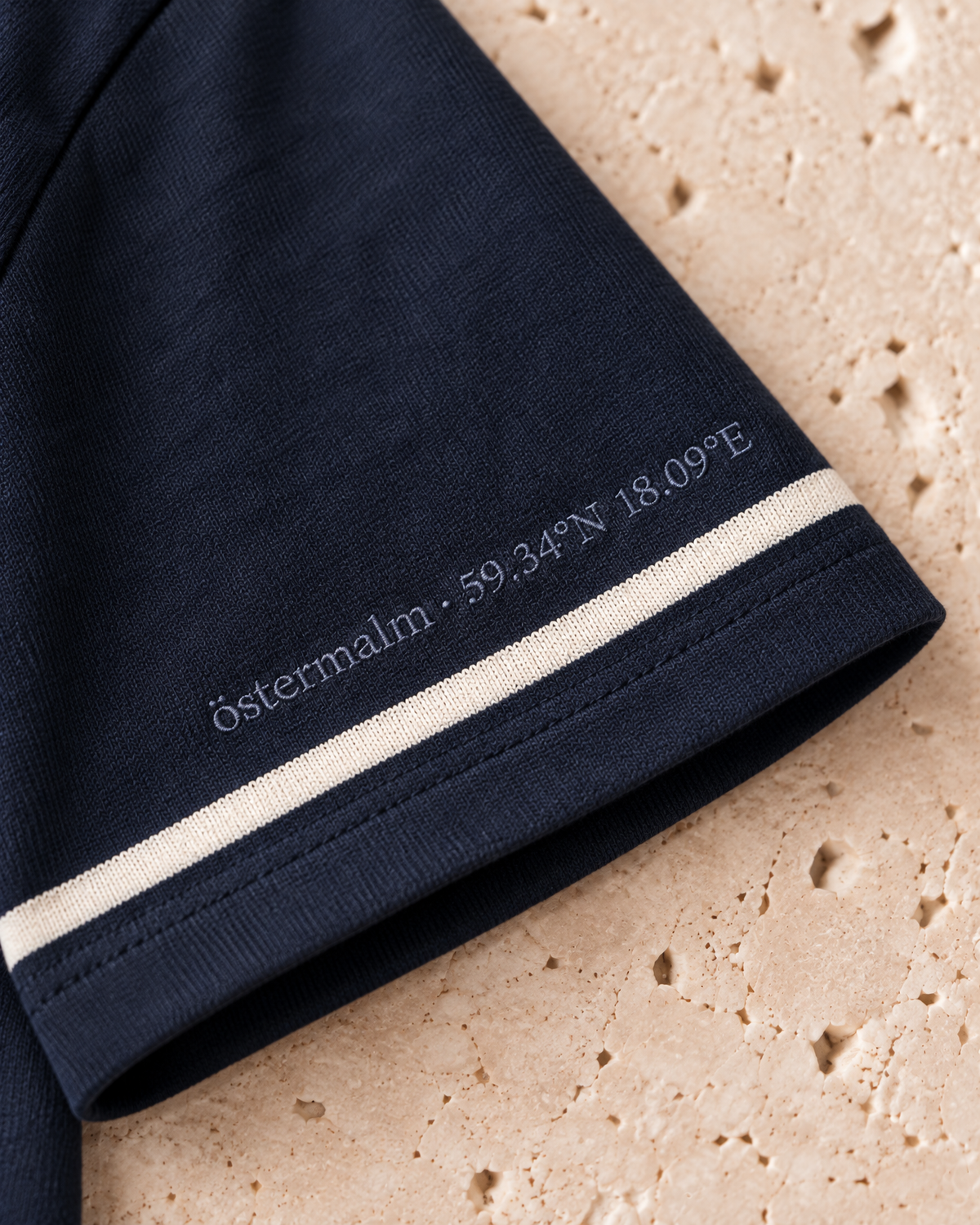 the heavyweight tee in navy · östermalm — sleeve embroidery detail