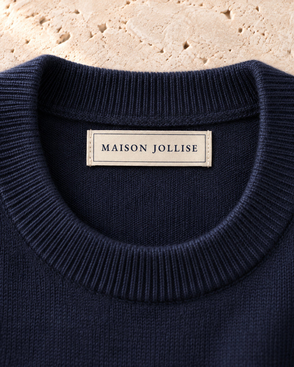 the merino crewneck in navy · östermalm — woven neck label