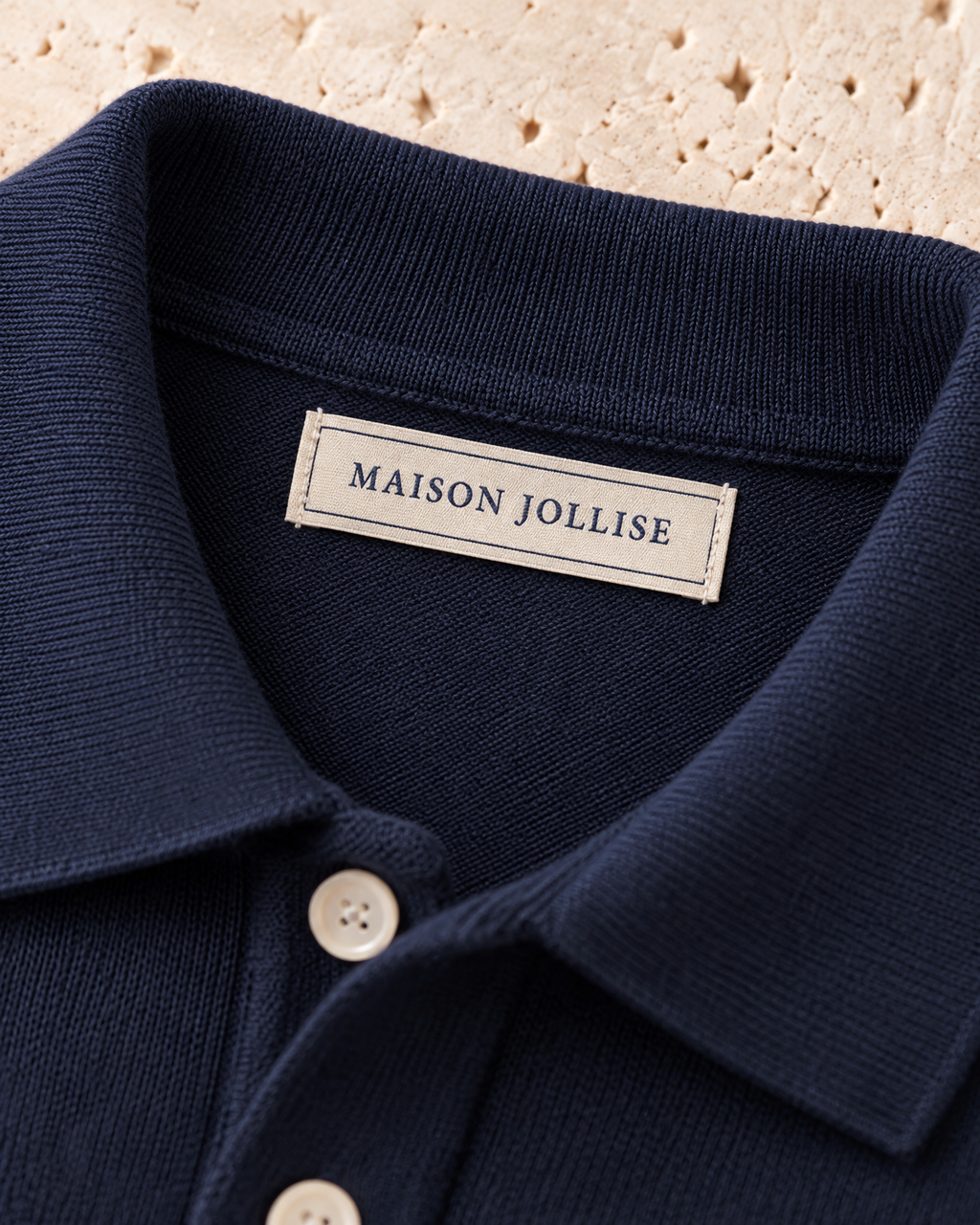 the knitted polo in navy · östermalm — woven neck label