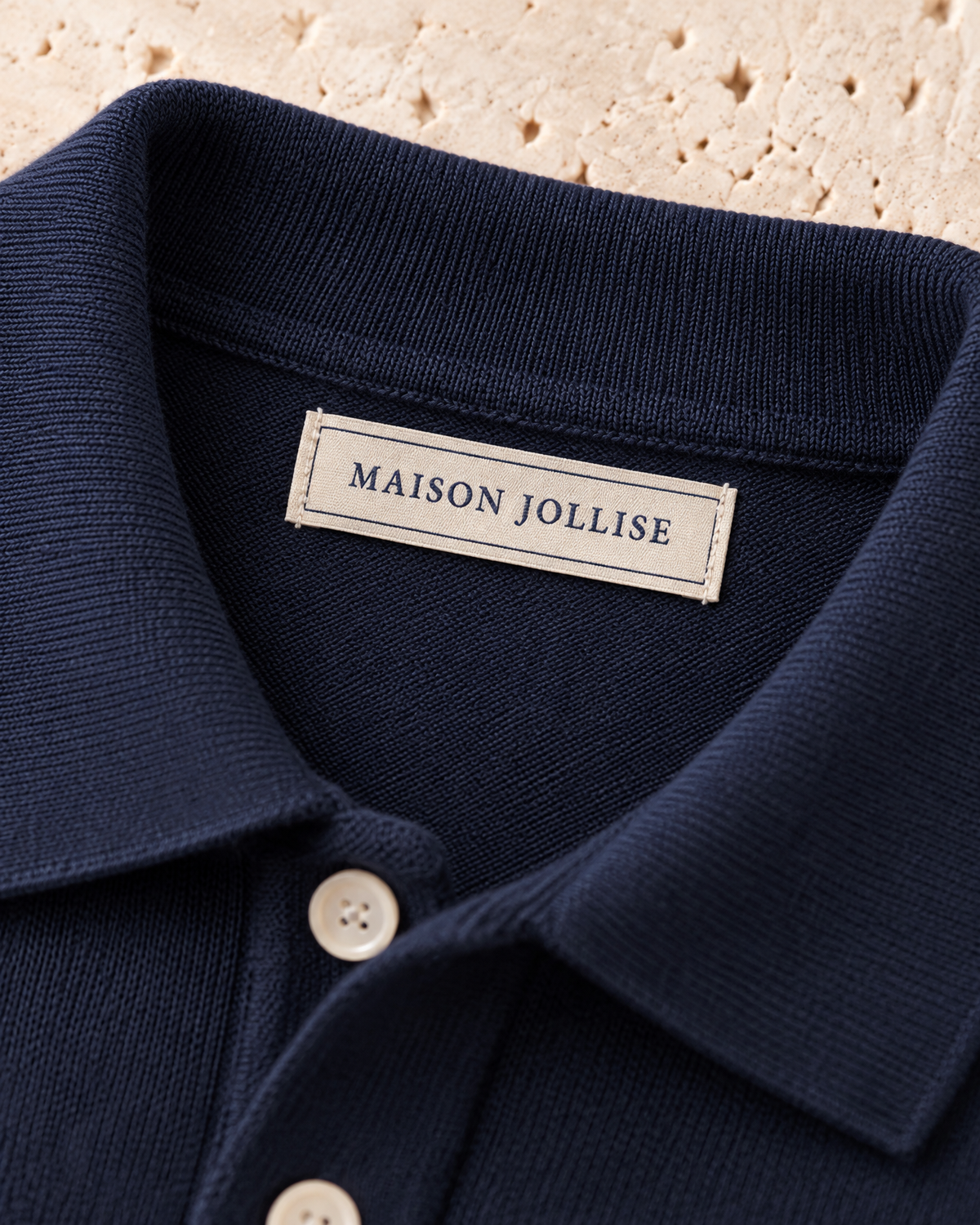 the knitted polo in navy · östermalm — woven neck label
