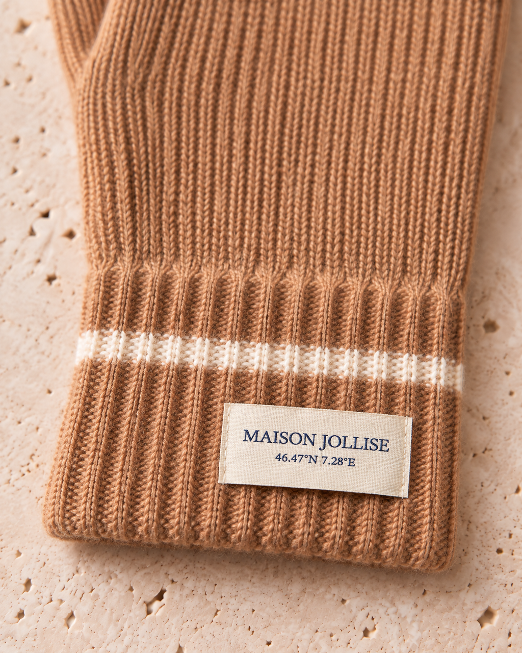 the snow line cashmere gloves in camel · gstaad — cuff label detail
